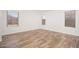 Bright bedroom showcasing wood-look flooring and natural light from multiple windows at 4605 W Beverly Rd, Laveen, AZ 85339