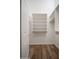 Walk-in closet featuring built-in shelving and wood-look flooring at 4605 W Beverly Rd, Laveen, AZ 85339