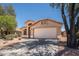 Single-story home showcasing a front-facing two-car garage, neutral-toned exterior, and desert landscaping at 4605 W Beverly Rd, Laveen, AZ 85339
