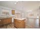 Open-concept kitchen with an island and wood cabinets, connecting to the dining area and living space at 4605 W Beverly Rd, Laveen, AZ 85339