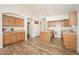 Updated kitchen features wood cabinets, an island, white appliances, and a bright, airy feel at 4605 W Beverly Rd, Laveen, AZ 85339