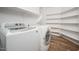 This is a laundry room with shelving, washer, and dryer at 4605 W Beverly Rd, Laveen, AZ 85339