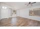 Bright living room showcasing a high ceiling, wood-look tile flooring, and ample natural light at 4605 W Beverly Rd, Laveen, AZ 85339