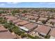 Expansive aerial view showcasing a neighborhood with uniform homes and manicured landscaping at 4649 E Sourwood Dr, Gilbert, AZ 85298