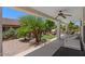 Covered patio with lush, tropical landscaping and seating area at 4649 E Sourwood Dr, Gilbert, AZ 85298