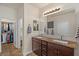 Bathroom featuring double sinks, granite counters, and walk-in closet at 4649 E Sourwood Dr, Gilbert, AZ 85298