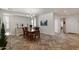 Bright dining room featuring stylish herringbone floors, a modern chandelier, and ample natural light at 4649 E Sourwood Dr, Gilbert, AZ 85298