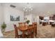 Open-concept dining area with warm wood floors, modern lighting, and easy access to the kitchen at 4649 E Sourwood Dr, Gilbert, AZ 85298