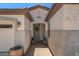 A view of the covered front entry featuring a decorative wreath and potted plants at 4649 E Sourwood Dr, Gilbert, AZ 85298