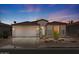 Charming single-story home with a well-maintained yard and a two-car garage at dusk at 4649 E Sourwood Dr, Gilbert, AZ 85298