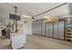Large garage with cabinets, storage, shelving, and hanging TV at 4649 E Sourwood Dr, Gilbert, AZ 85298
