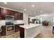 Open kitchen with a large island, stainless steel appliances, and seamless flow into the dining area at 4649 E Sourwood Dr, Gilbert, AZ 85298