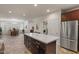 Modern kitchen featuring a large island with marble countertop, stainless steel appliances, and dark cabinetry at 4649 E Sourwood Dr, Gilbert, AZ 85298