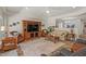 Open living room featuring a media center, neutral color palette, ceiling fan and wood look flooring at 4649 E Sourwood Dr, Gilbert, AZ 85298