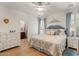 Bright main bedroom features a king bed, light wood floors, and natural light at 4649 E Sourwood Dr, Gilbert, AZ 85298