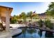 Inviting outdoor space with a covered patio, lush greenery, a pool, and picturesque views of the surrounding landscape at 5023 S Dusty Coyote Trl, Gold Canyon, AZ 85118