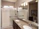 Bathroom featuring double sinks with granite countertops and tiled shower at 5023 S Dusty Coyote Trl, Gold Canyon, AZ 85118