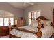 Bedroom features large bed with luxurious wood carved frame and details at 5023 S Dusty Coyote Trl, Gold Canyon, AZ 85118