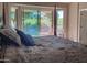 Bedroom featuring king bed and sliding glass doors to backyard and view at 5023 S Dusty Coyote Trl, Gold Canyon, AZ 85118