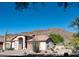 Charming single-story home featuring desert landscaping, a two-car garage, and a backdrop of beautiful mountain views at 5023 S Dusty Coyote Trl, Gold Canyon, AZ 85118