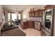 Bright kitchen featuring stainless steel appliances, granite countertops, custom cabinetry, and a breakfast nook at 5023 S Dusty Coyote Trl, Gold Canyon, AZ 85118