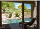 Backyard pool featuring outdoor seating, landscaping, and golf course view at 5023 S Dusty Coyote Trl, Gold Canyon, AZ 85118