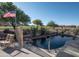 Sparkling pool with golf course views, desert landscaping, and American flag at 5023 S Dusty Coyote Trl, Gold Canyon, AZ 85118