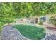 Serene backyard featuring a well-maintained lawn, shade trees, and a covered patio, ideal for relaxation at 5283 W Dublin Ct, Chandler, AZ 85226
