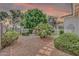 Expansive backyard featuring mature trees, rock landscaping, and a brick paver walkway at 5283 W Dublin Ct, Chandler, AZ 85226