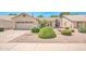 Charming single-story home with manicured landscaping, including green shrubbery and desert rock at 5283 W Dublin Ct, Chandler, AZ 85226