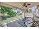 Relaxing covered patio with comfortable seating overlooking the private backyard with lush landscaping at 5283 W Dublin Ct, Chandler, AZ 85226