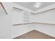 Spacious walk-in closet featuring custom shelving and wooden closet rods to maximize storage space at 5283 W Dublin Ct, Chandler, AZ 85226