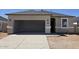 Charming single-story home featuring a two-car garage, a well-maintained stucco exterior, and a neatly paved driveway at 5457 E Mearn Rd, San Tan Valley, AZ 85140