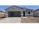 Charming single-story home with a spacious two-car garage and low-maintenance front yard at 5575 E Mearn Rd, San Tan Valley, AZ 85140