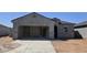 Unfinished home exterior showing the driveway and garage at 5575 E Mearn Rd, San Tan Valley, AZ 85140