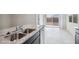 Modern kitchen featuring an island, stainless steel appliances, and dark wood cabinetry at 5575 E Mearn Rd, San Tan Valley, AZ 85140