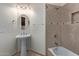 Cozy bathroom with a pedestal sink, tiled shower and tub and modern fixtures at 6202 E Mckellips Rd # 25, Mesa, AZ 85215