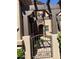 Charming front entrance features a stone archway, pergola, and decorative metal gate at 6202 E Mckellips Rd # 25, Mesa, AZ 85215