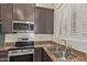 Modern kitchen featuring stainless steel appliances, granite countertops, and stylish cabinetry at 6202 E Mckellips Rd # 25, Mesa, AZ 85215
