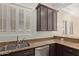 Close up of kitchen featuring granite countertops, stainless steel sink, and ample storage at 6202 E Mckellips Rd # 25, Mesa, AZ 85215