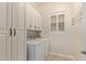 Laundry room with white cabinets, a folding rack, and a window that allow natural light at 6202 E Mckellips Rd # 25, Mesa, AZ 85215