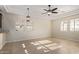 Bright, expansive living room with neutral tile flooring, tray ceiling, and ample natural light at 6202 E Mckellips Rd # 25, Mesa, AZ 85215