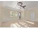 Bright, expansive living room with neutral tile flooring, tray ceiling, and ample natural light at 6202 E Mckellips Rd # 25, Mesa, AZ 85215