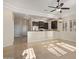 Bright living room with modern ceiling fan and adjacent kitchen with stainless steel appliances at 6202 E Mckellips Rd # 25, Mesa, AZ 85215