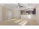 Open-concept living room with modern ceiling fan and adjacent kitchen with stainless steel appliances at 6202 E Mckellips Rd # 25, Mesa, AZ 85215