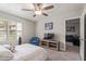 Comfortable bedroom with ceiling fan, chair, TV, and view into an additional room at 6885 E Cochise Rd # 127, Paradise Valley, AZ 85253