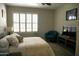 Comfortable bedroom featuring a bed, lounger, and a large window with plantation shutters at 6885 E Cochise Rd # 127, Paradise Valley, AZ 85253