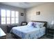 Bright and airy bedroom featuring a queen-sized bed, ceiling fan and shuttered windows at 6885 E Cochise Rd # 127, Paradise Valley, AZ 85253