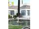 Exterior shot of home featuring water feature, desert landscaping, and dark trimmed windows at 6885 E Cochise Rd # 127, Paradise Valley, AZ 85253