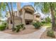 Exterior view of a two-story condo featuring a private balcony and mature trees at 6885 E Cochise Rd # 127, Paradise Valley, AZ 85253